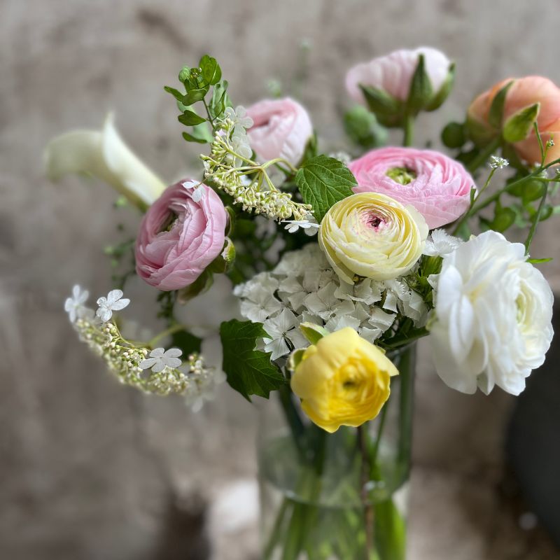 White and pink funeral flowers against a dark background